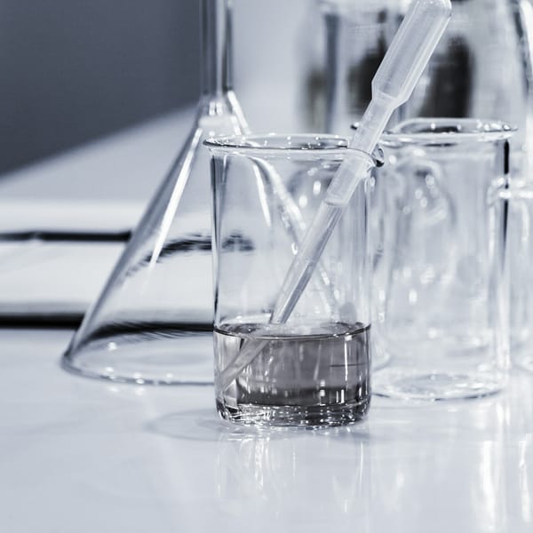 Water sample in a glass beaker with a pipette